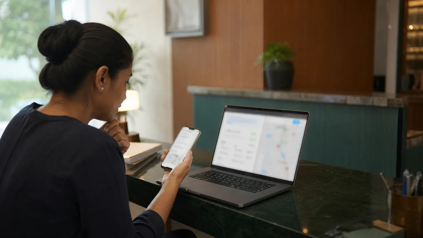 Google Business Profile checklist for dental clinics: a clinic administrator noticing inconsistent hours, map pin and contact details across phone and laptop.